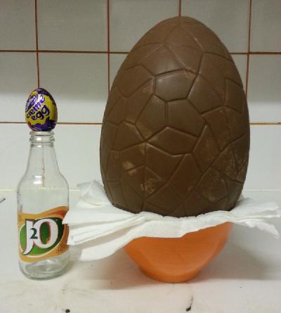 Photo of giant creme egg next to normal sized creme egg for scale