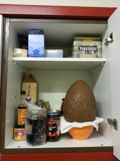 Photo of giant creme egg in cupboard with lots of teas