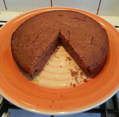 Photo of plain brown cake with one slice cut out