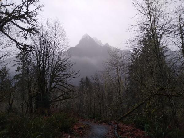 A sharp, distant peak, vanishing in the rain.