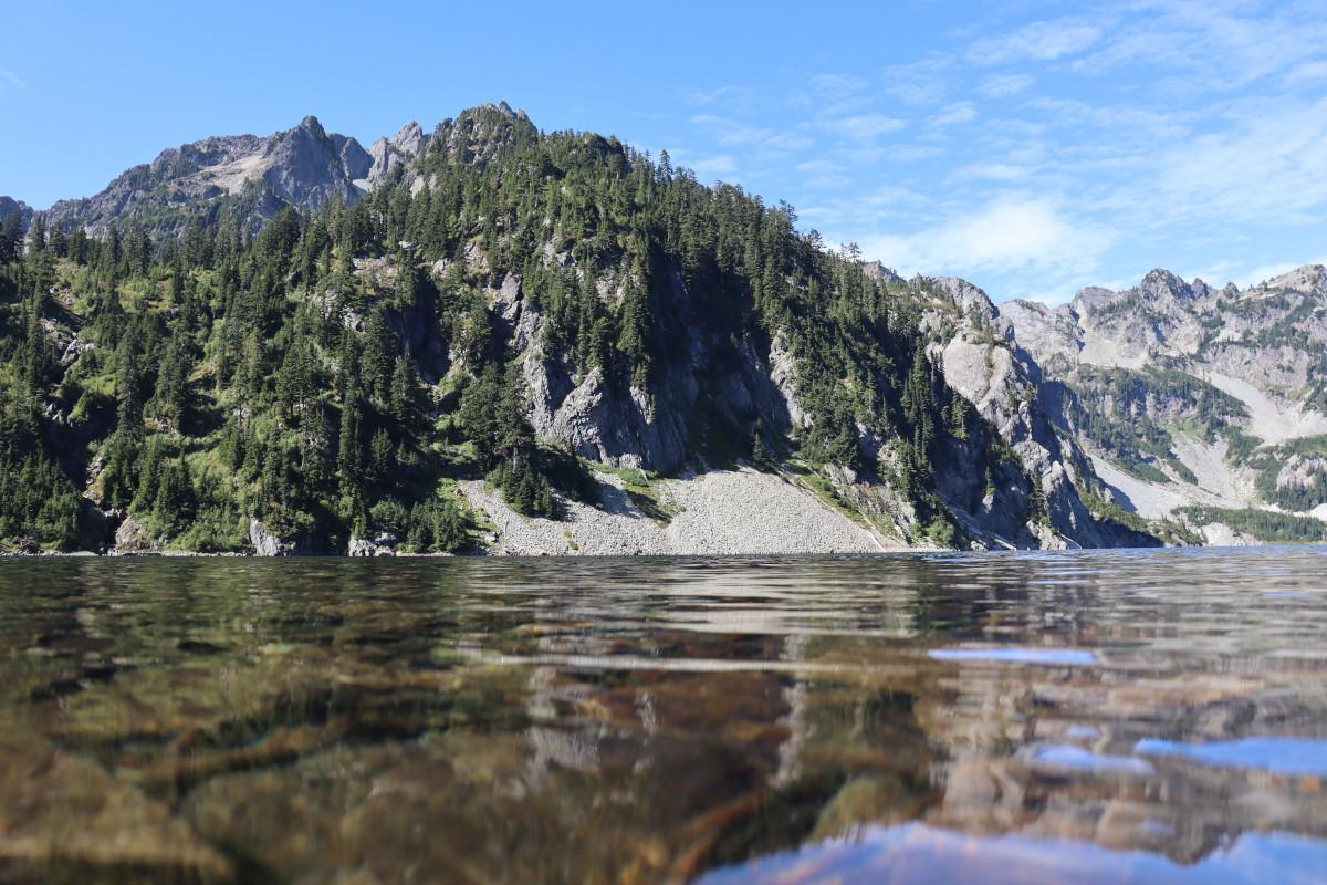 View across the lake of the bright, clear water.