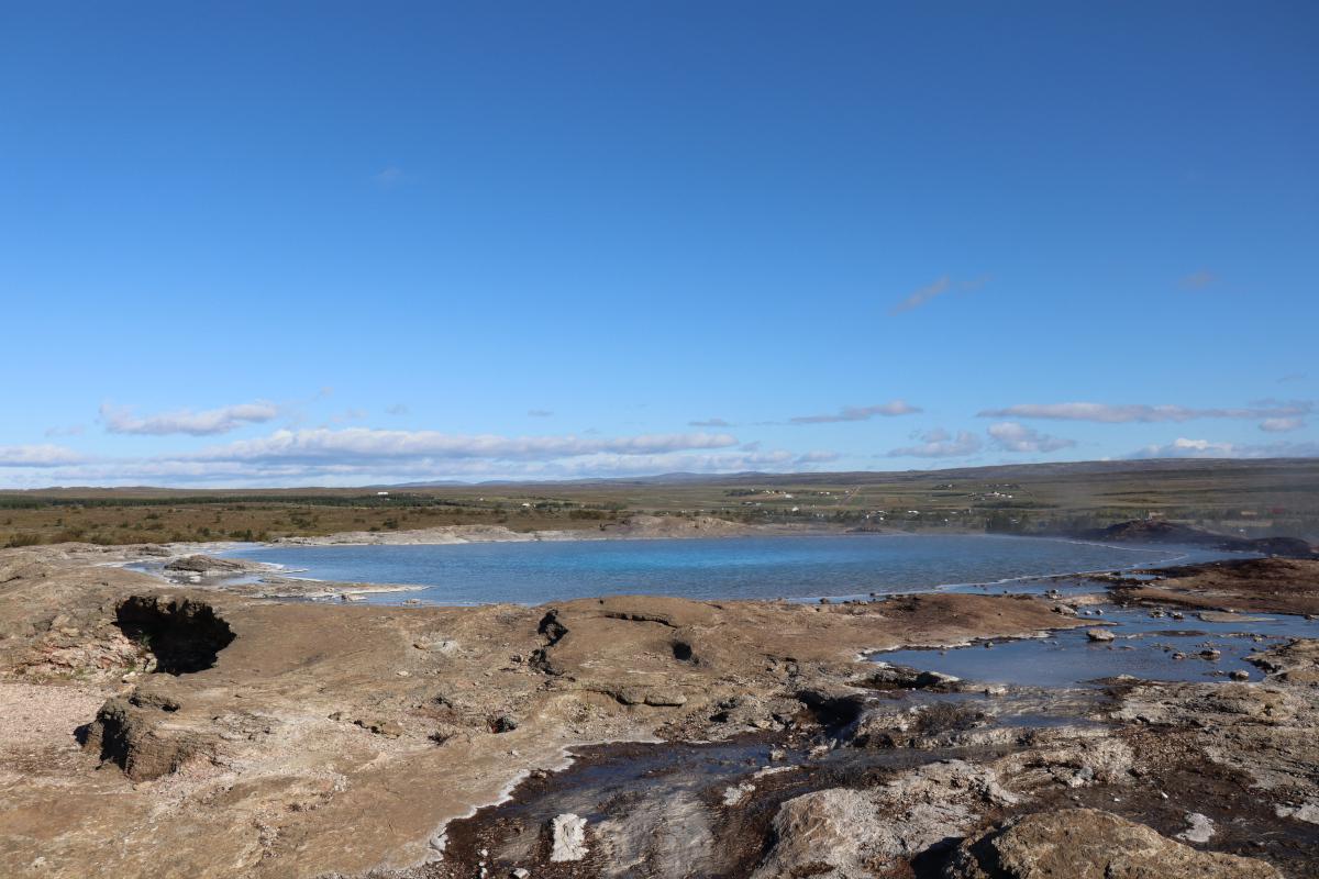 Photo of Geysir from higher up so you can see the pool of hot water.