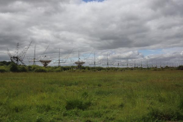 A row of 22 crescent moon shaped antennas, disappearing into the distance.