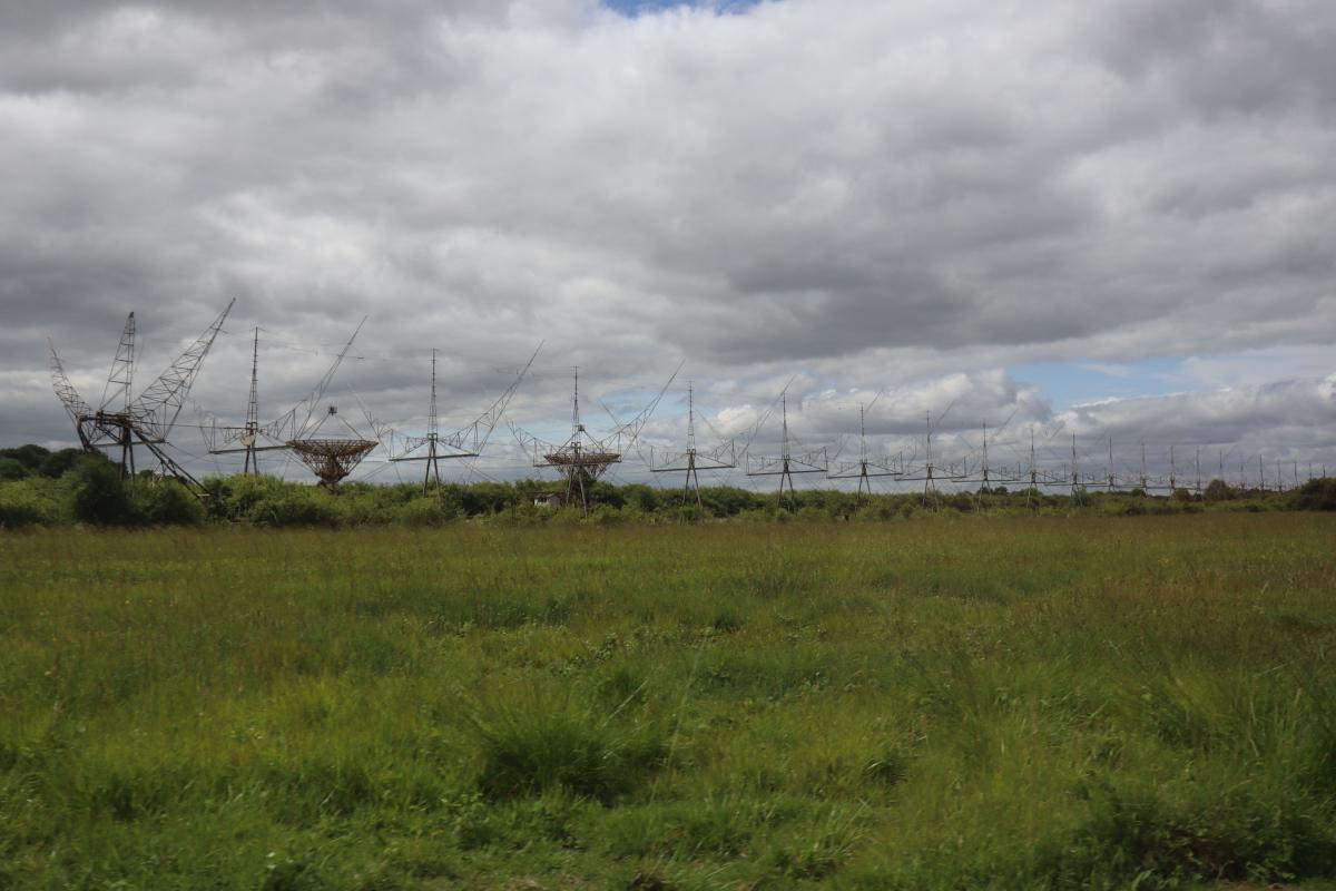 A row of 22 crescent moon shaped antennas, disappearing into the distance.