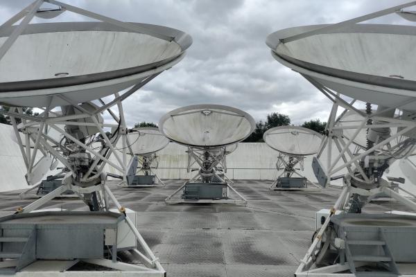 Seven medium sized parabolic receivers, all are static, encircled by an angled wall.