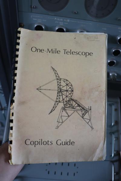 An old spiral bound book with a black and white radio telescope on the front cover.