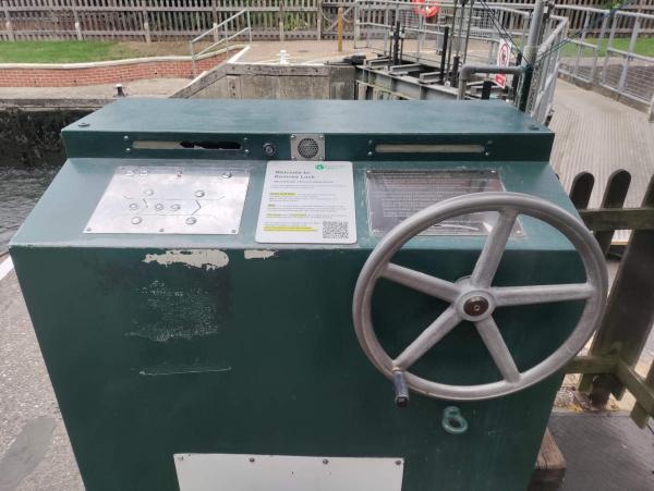 A metal control panel with buttons and a large wheel.