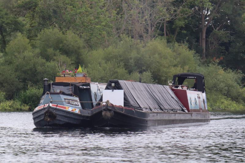 Two canal boats lashed together.