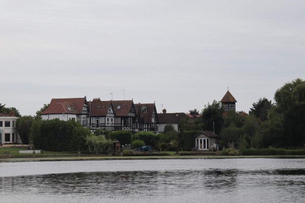 A row of Tudor style buildings along the river side.