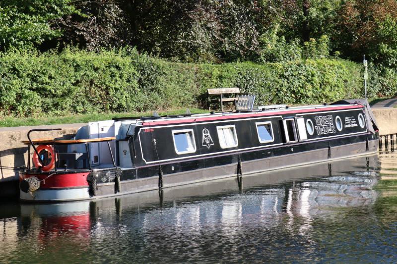 A black canal boat with a Darth Vader logo.