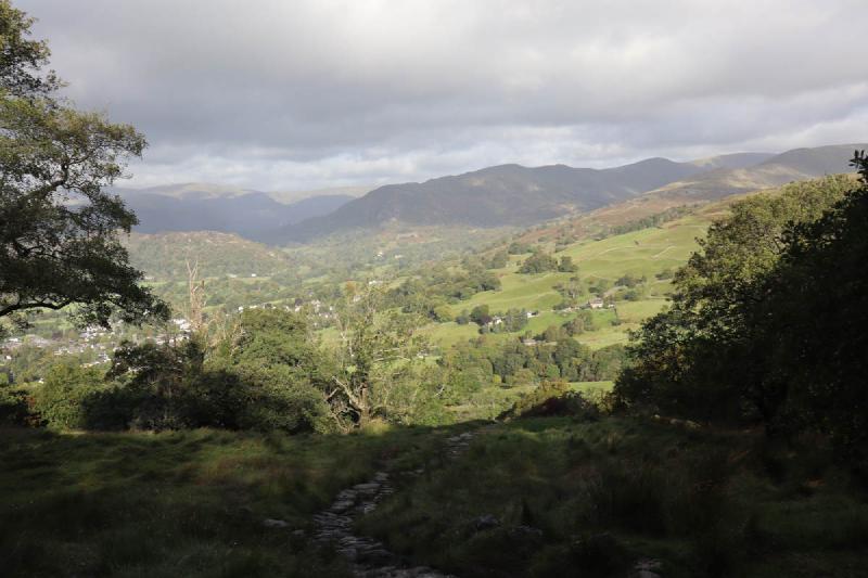 Dark surroundings with parts of Ambleside in the distance.