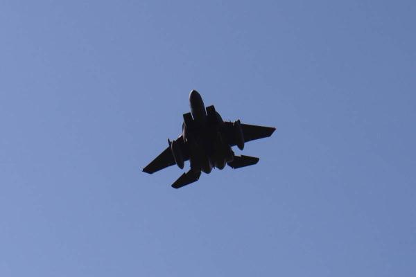 Looking up at a figher jet.