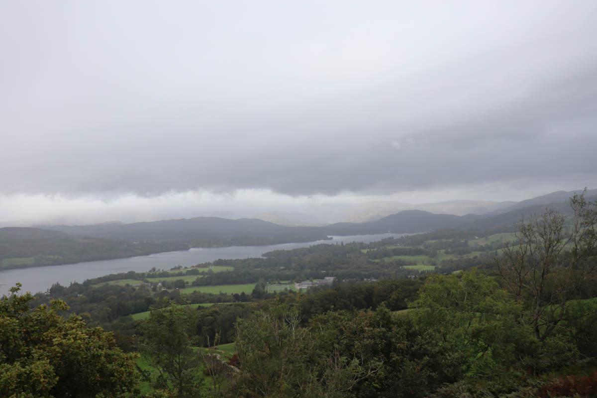 Grey, overcast clouds with a lake in the distance.