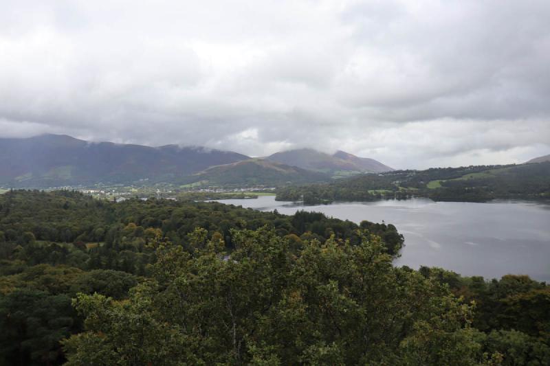 Keswick in the distance with some woods in the foreground.