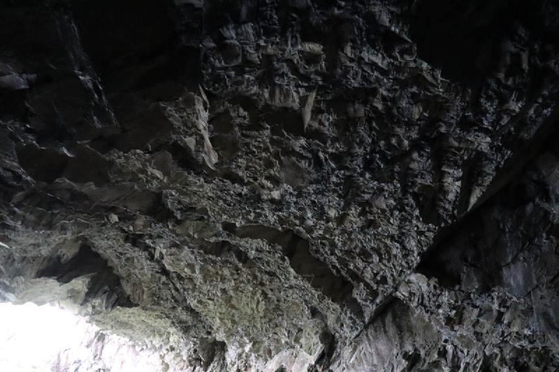 A view of the cave ceiling with jagged spikes.